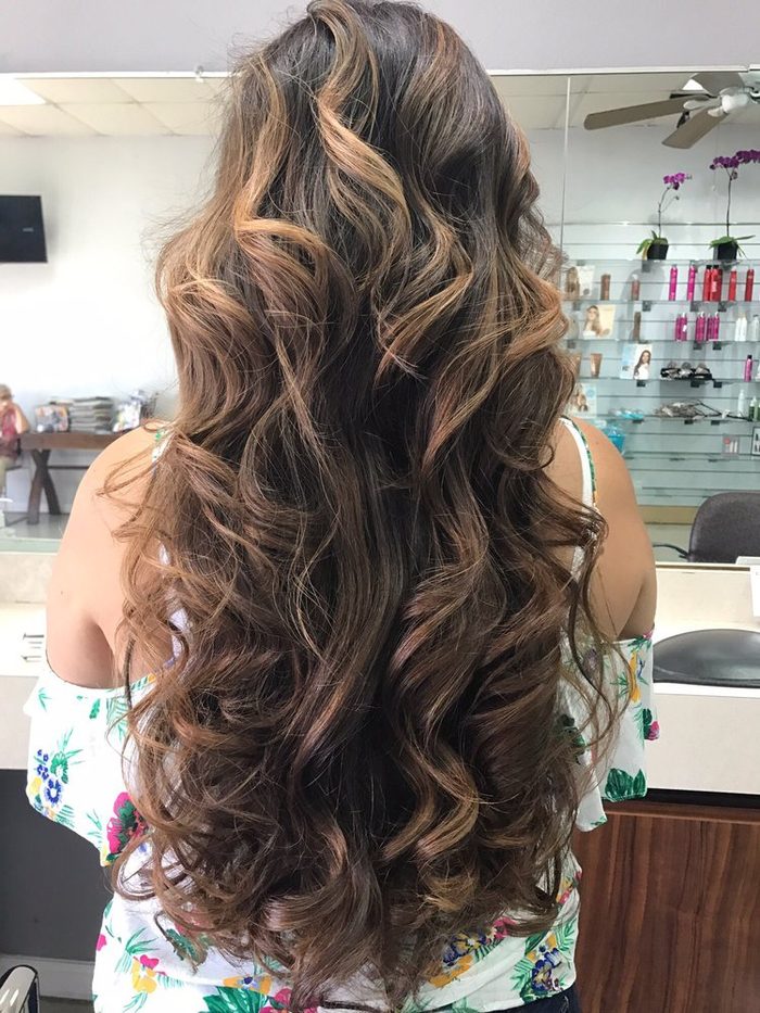 Long caramel waves with lighter pieces around the ends.