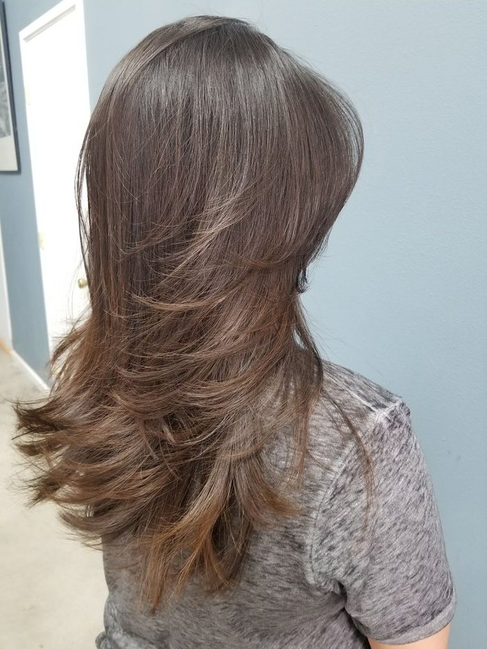 A chin-length bob in a soft brown, blown out smooth.